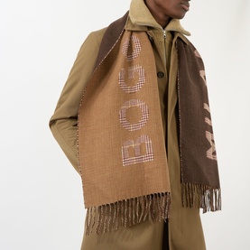 Model with Boggi Milano Logo Jacquard Fringed Scarf in hazelnut, featuring tonal check print and jacquard logo, styled over olive coat
