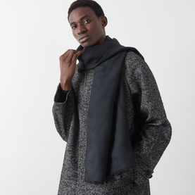 Model with Boggi Milano Solid Eyelash Fringed Scarf in black, draped over grey marl wool coat. Lightweight wool-silk with fringed edges.