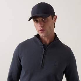 Model with Boggi Milano Perforated Baseball Cap in navy blue, curved visor and embroidered logo, styled with a navy zip-neck sweatshirt