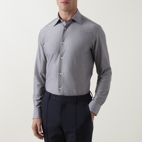 Model wearing Boggi Milano light blue striped casual shirt, styled with navy tailored trousers, long sleeves with button cuffs