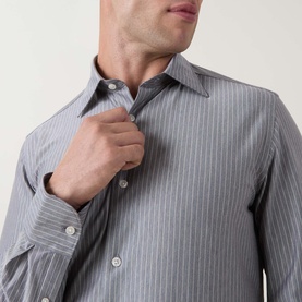 Model wearing Boggi Milano light blue pinstripe casual shirt in cotton-polyester blend, buttoning collar, close-up detail view