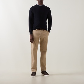 Model wearing Boggi Milano navy blue wool crew neck jumper, styled with tan chinos and dark trainers.