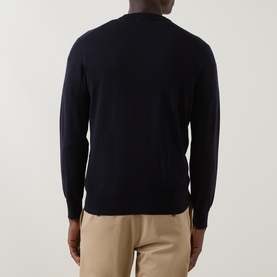 Model wearing Boggi Milano navy blue wool crew neck jumper, back view, styled with beige trousers.