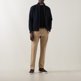 Model wearing Boggi Milano Navy Blue wool crew neck, styled with a navy zip jacket, beige chinos and dark brown loafers.