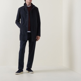 Model wearing Boggi Milano Longline Car Coat in navy blue with stand collar, styled with burgundy jumper, navy trousers and navy suede trainers.