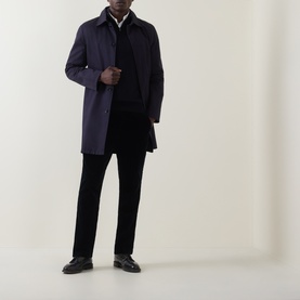 Model wearing Boggi Milano Navy Blue Wool Half Zip, styled with a navy mac coat and black trousers and loafers.