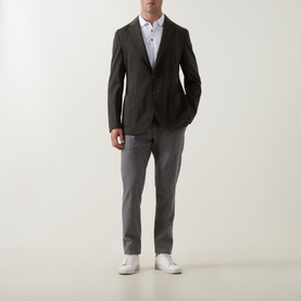 Model wearing Boggi Milano Madison Sweatshirt Blazer in Military Green, styled with grey trousers, white shirt and white trainers.