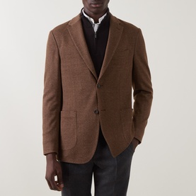 Model wearing Boggi Milano brick red wool-cotton blend blazer jacket, styled with dark knitwear and charcoal trousers