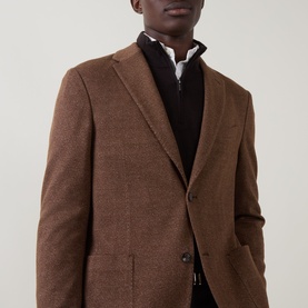 Model wearing Boggi Milano brick red wool-cotton blazer jacket, styled with dark zip-neck jumper and white shirt underneath