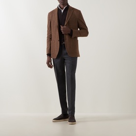 Model wearing Boggi Milano brick red wool-cotton blazer, styled with dark trousers, navy knitwear, white shirt and brown suede trainers.