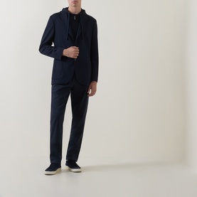 Model wearing Boggi Milano navy blue jacket with matching trousers, black hoodie, and dark trainers.