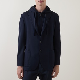 Model wearing Boggi Milano navy blue jacket with patch pockets and two-button front, styled over a navy hoodie.
