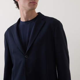 Model wearing Boggi Milano navy blue single-breasted jacket with two-button fastening, styled with a navy crew-neck T-shirt.