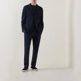 Model wearing Boggi Milano navy blue unstructured blazer jacket, styled with matching navy trousers and dark trainers.