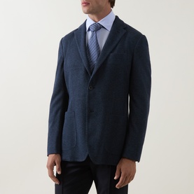 Model wearing Boggi Milano Micro Textured Single-Breasted Blazer in indigo, styled with a light blue shirt and striped tie.