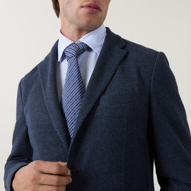 Model wearing Boggi Milano Micro Textured Single-Breasted Blazer in indigo, styled with a light blue shirt and striped tie.