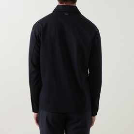 Model wearing Boggi Milano Wool Tech Zip Overshirt in navy blue, rear view showing logo plaque and long sleeves, styled with navy trousers