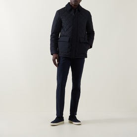 Model wearing Boggi Milano Diamond-Quilted Padded Jacket in navy blue with corduroy collar, styled with navy trousers and grey trainers.