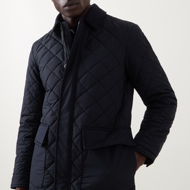 Model wearing Boggi Milano Diamond-Quilted Padded Jacket in navy blue, with contrasting collar, snap button placket, and hip flap pockets.