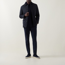 Model wearing Boggi Milano Diamond-Quilted Padded Jacket in navy blue with corduroy collar, styled with navy trousers and suede trainers.