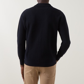 Model wearing Boggi Milano Tech Half-Zip Sweater in navy blue, shown from behind, styled with beige trousers.