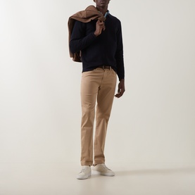 Model wearing Boggi Milano Tech Half-Zip Sweater in navy blue, styled with tan chinos, a camel jacket over shoulder, and white trainers.