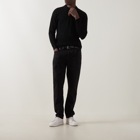 Model wearing Boggi Milano Tech Half-Zip Sweater in black with matching black trousers, belt, and white trainers.