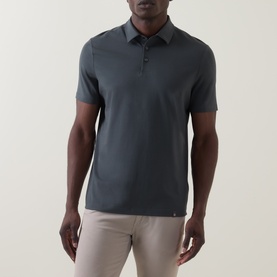 Model wearing Boggi Milano dark green cotton polo shirt with three-button placket and short sleeves, styled with beige trousers