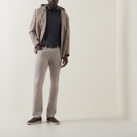 Model wearing Boggi Milano Dark Green polo, styled with beige jacket, light trousers and dark loafers
