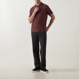 Model wearing Boggi Milano Brick Red polo shirt, styled with dark charcoal trousers and black trainers.