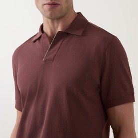 Model wearing Boggi Milano Brick Red polo shirt, short sleeves, zip-placket collar detail, close-up shot showing texture and fit.
