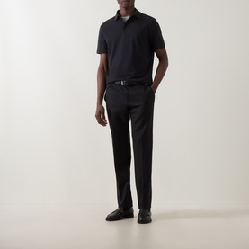 Model wearing Boggi Milano Supima Solid Polo Shirt in black with matching black trousers, belt, and loafers.