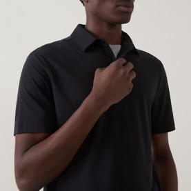 Model wearing Boggi Milano Supima Solid Polo Shirt in black, with polo collar, short sleeves, and button fastenings, close-up detail view.