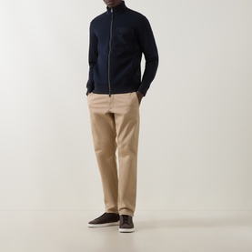Model wearing Boggi Milano Light Scuba Zip Sweatshirt in navy blue with funnel neck and chest pocket, styled with beige trousers and dark trainers.