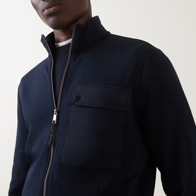Model wearing Boggi Milano Light Scuba Zip Sweatshirt in navy blue, showing funnel neck, zip fastening and contrast patch chest pocket.
