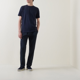 Model wearing Boggi Milano Supima Solid T-Shirt in navy, round neck, short sleeves, styled with matching navy trousers and grey canvas shoes.