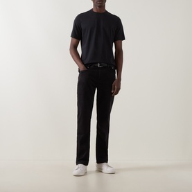 Model wearing Boggi Milano Supima Solid T-Shirt in black, round neck, short sleeves, styled with black trousers and white trainers.