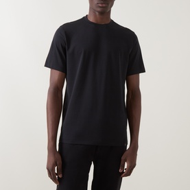 Model wearing Boggi Milano Supima Solid T-Shirt in black, featuring round neck and short sleeves, styled with black trousers.