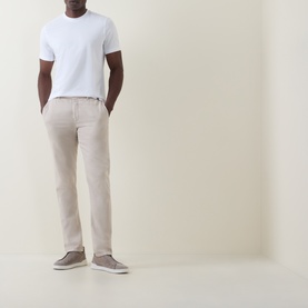 Model wearing Boggi Milano white cotton-elastane T-shirt, styled with stone chinos and grey canvas shoes.