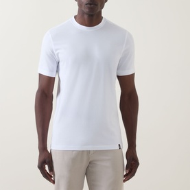 Model wearing Boggi Milano white crew neck T-shirt in cotton-elastane blend, styled with light beige trousers.