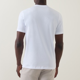 Model wearing Boggi Milano white cotton-elastane T-shirt, shown from the back, styled with light beige trousers.