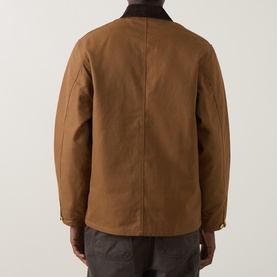 Model wearing Carhartt casual jacket in Hamilton Brown, rear view, showing corduroy collar and relaxed fit cotton construction