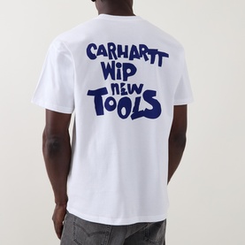 Model wearing Carhartt New Tools Logo Back Graphic T-Shirt in white, showing bold navy back print, round neck, short sleeves