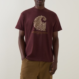 Model wearing Carhartt Entrance Logo Graphic T-Shirt in Amarone, featuring lion graphic print on chest, round neck and short sleeves, styled with