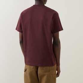 Model wearing Carhartt Entrance Logo Graphic T-Shirt in Amarone, rear view, short sleeves, crew neck, styled with tan cargo trousers.