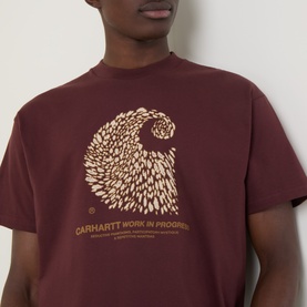 Model wearing Carhartt Entrance Logo Graphic T-Shirt in Amarone, featuring a graphic wave print with logo text on chest.