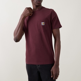 Model wearing Carhartt Logo Chest Pocket T-Shirt in Amarone, crew neck, short sleeves, logo patch chest pocket, styled with black trousers.