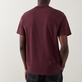 Model wearing Carhartt Logo Chest Pocket T-Shirt in Amarone, back view showing crew neck, short sleeves and straight hemline.