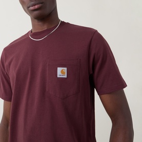 Model wearing Carhartt Logo Chest Pocket T-Shirt in Amarone, featuring logo patch chest pocket. Styled with a silver chain necklace.