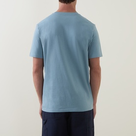 Model wearing Carhartt Crew Neck T in Citadel blue, rear view, paired with navy shorts. 100% cotton, short sleeves.